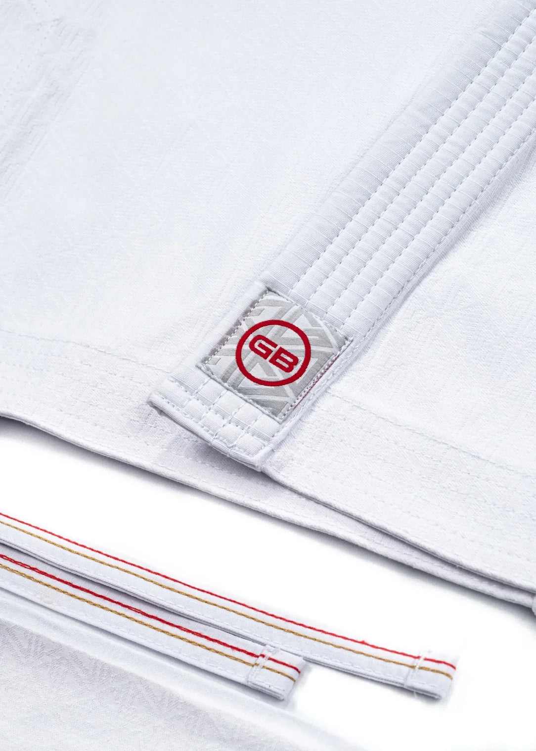 Detail of the 40 Year Anniversary Women's Kimono GB collar tag and red, gold, and white-stitched traditional draw-cord waistband