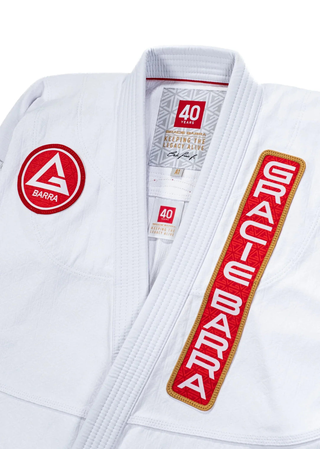 40 Year Anniversary Kimono upper chest view with Barra Shield, Gracie Barra Patch, and Keeping the Legacy Alive neck label